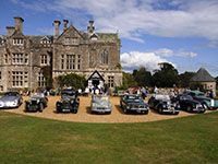 Classic cars displayed in front of Palace House